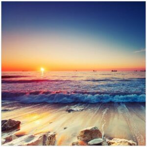 Wallario Möbelfolie Sonnenuntergang am Meer mit Wellen am Strand